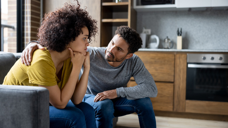Man and woman sitting on couch