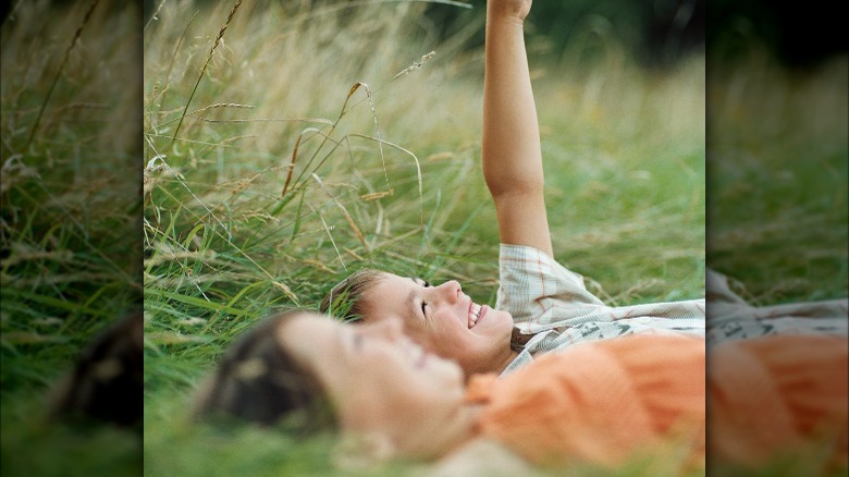 Childhood friends lay in meadow