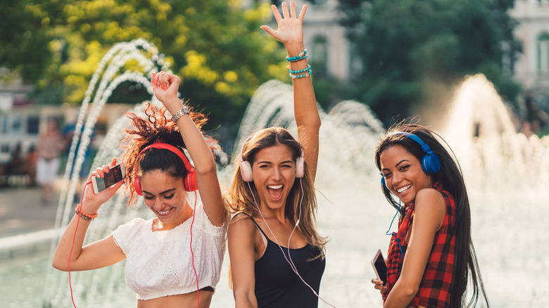 friends dancing with headphones