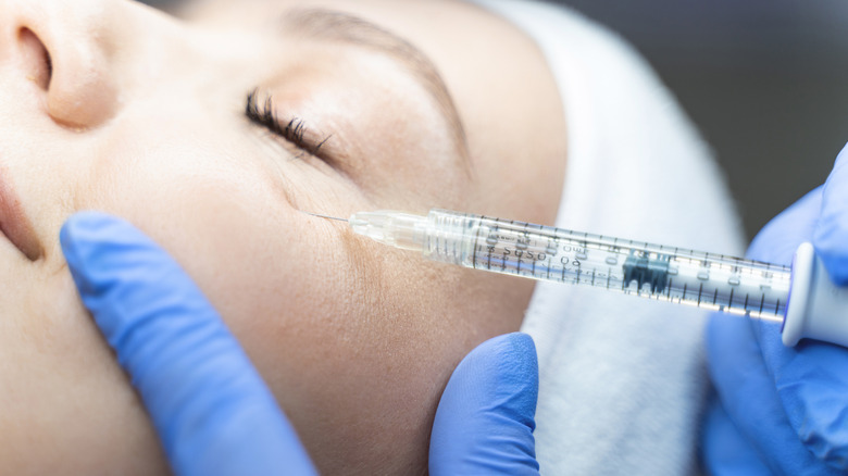 woman being injected with filler