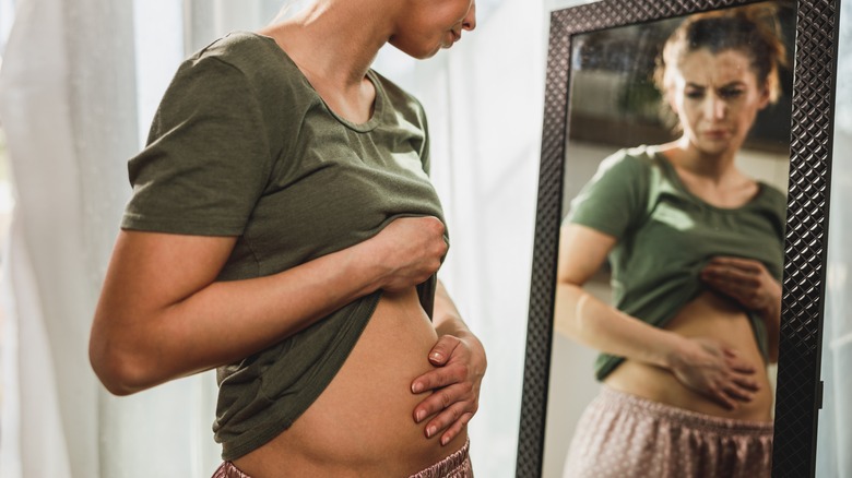 A woman with a bloated tummy