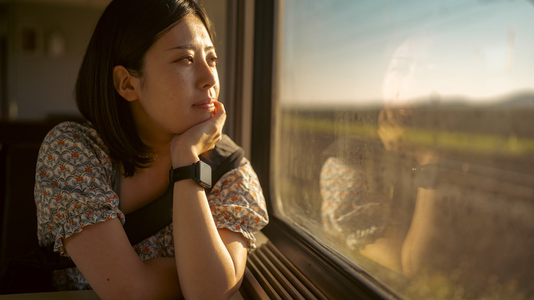 Person looking out window, thinking