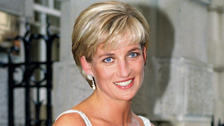 Princess Diana in a white dress with her bixie cut