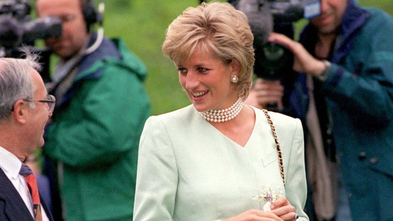 Princess Diana wearing choker pearls and a mint skirt suit