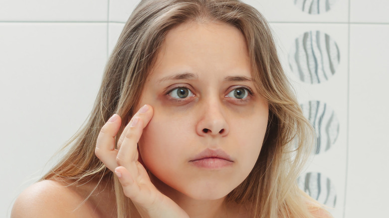 person looking at their eyebrows