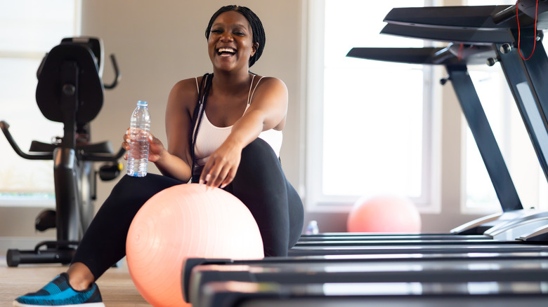 A woman working with an exercise ball in a gym