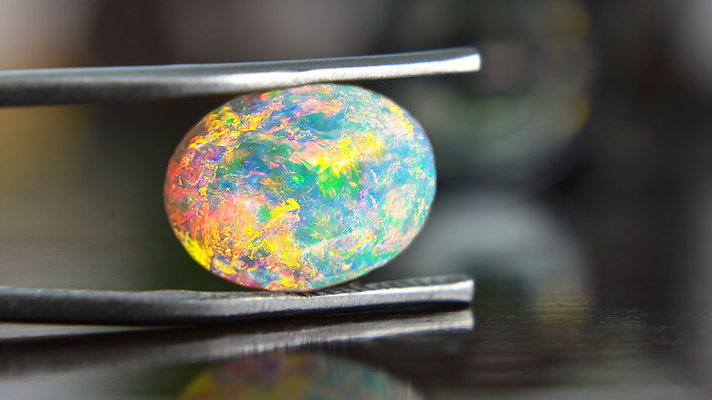 Opal gemstone in jewelry clamp