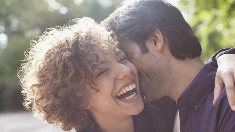 Woman and man embracing 
