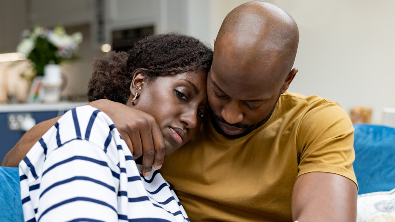 couple embracing on couch