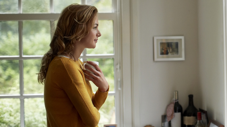 happy woman holding coffee