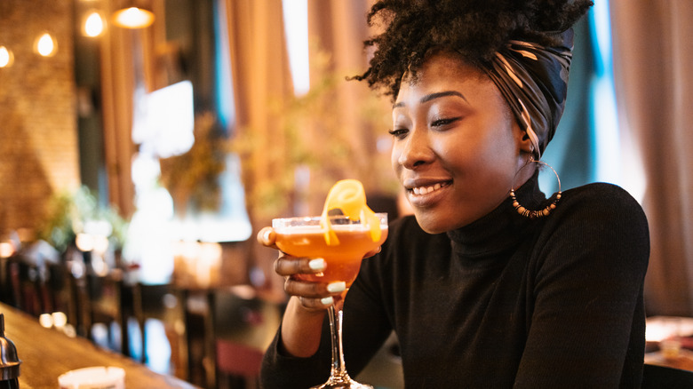A woman drinking a cocktail
