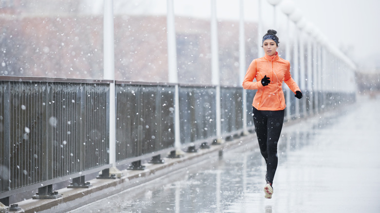 Woman runs in rain