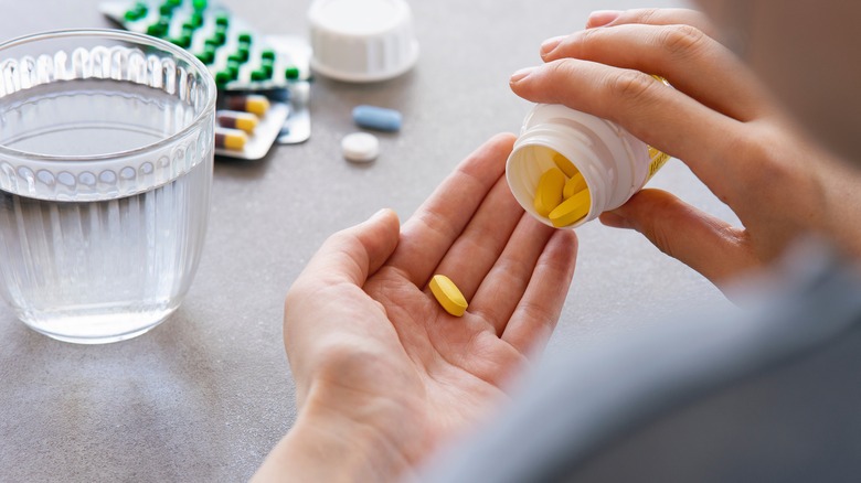 person holding medicine in hand