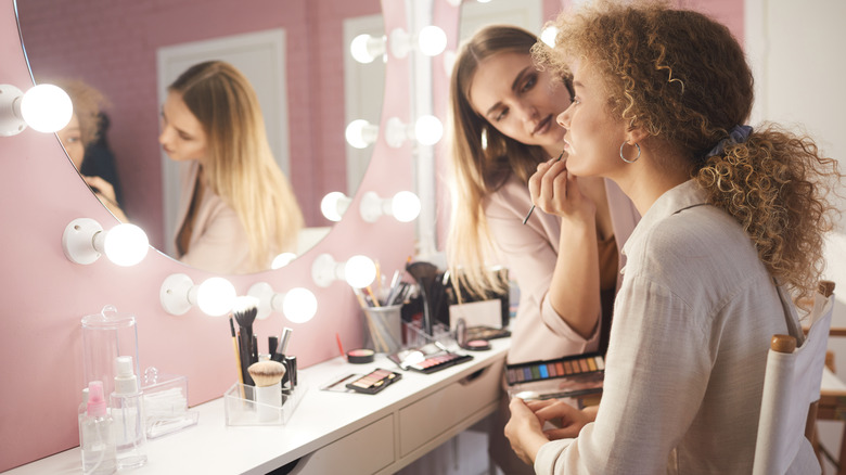Woman getting makeup done