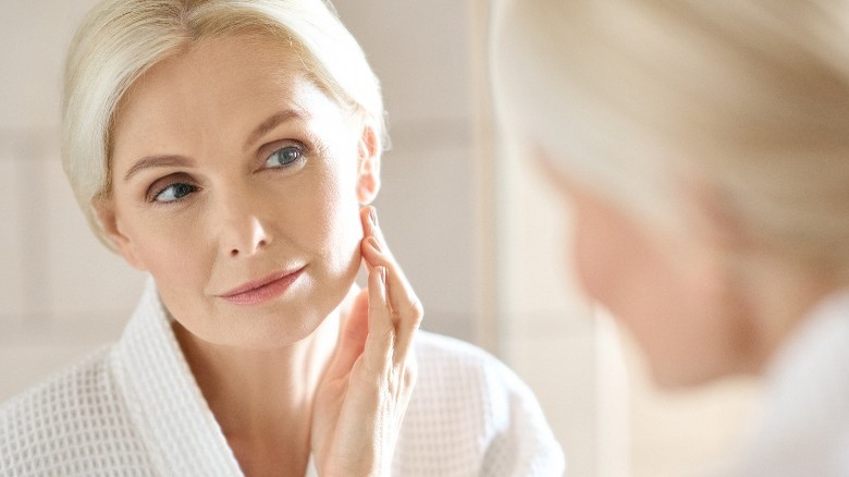 Older woman looking in mirror