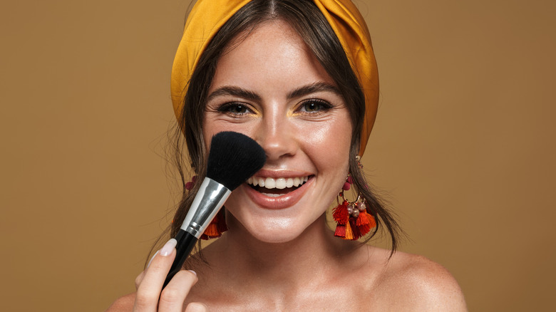 Woman applying face powder