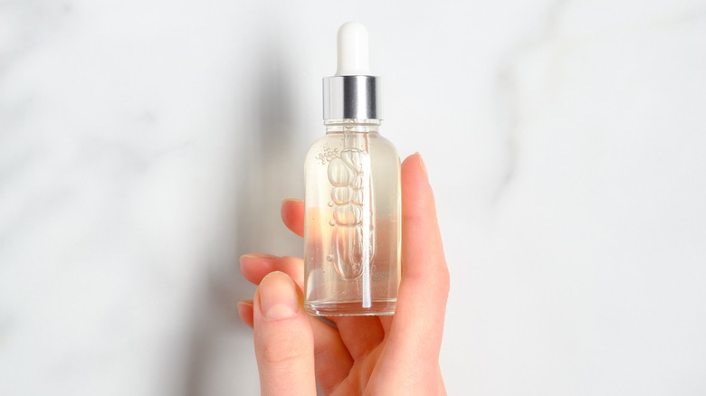 Person holding serum bottle