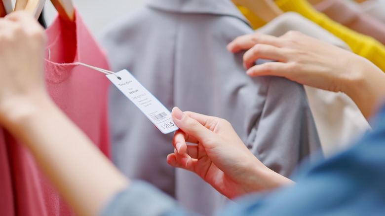 woman reads clothing tags