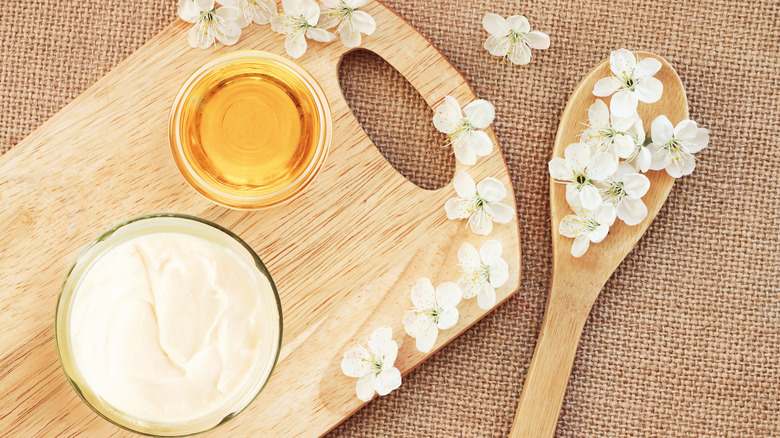 Honey and cream on wooden board