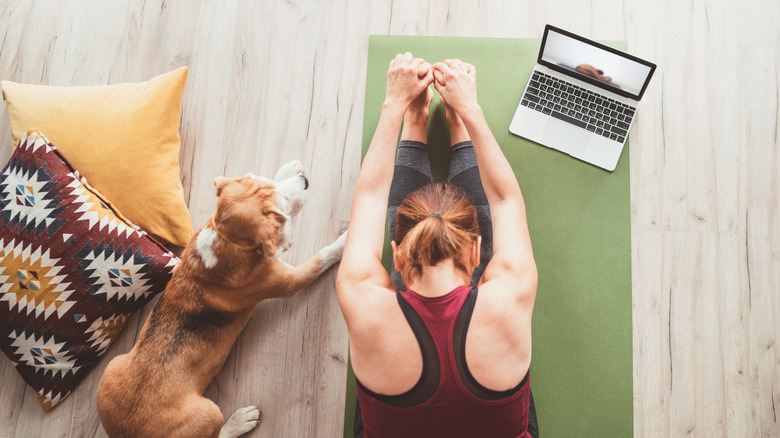 Woman stretches on a mat 