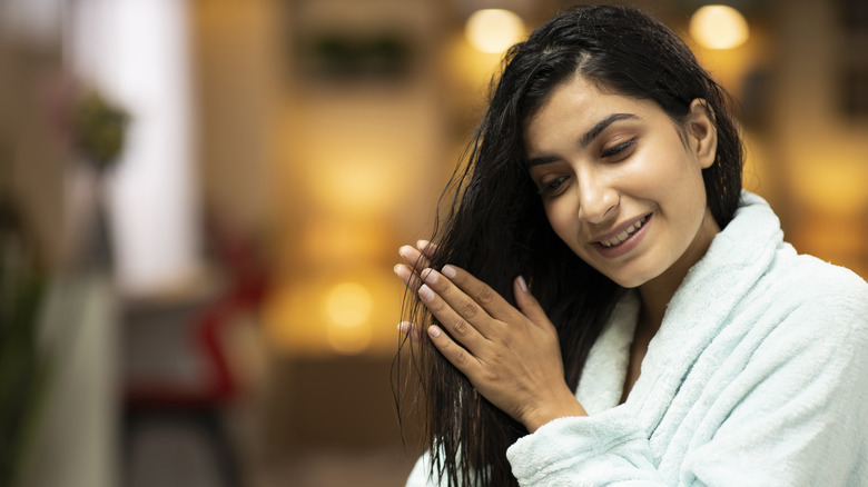 Woman applying hair oil