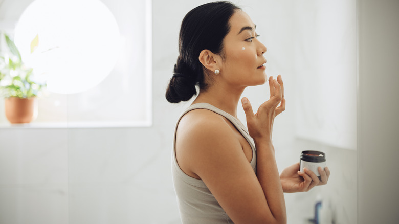woman applying skincare