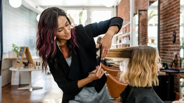 hairstylist trimming hair