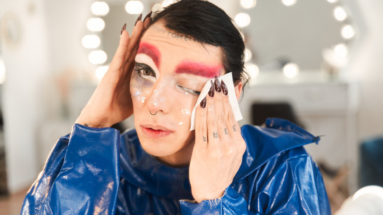 A drag queen removing makeup