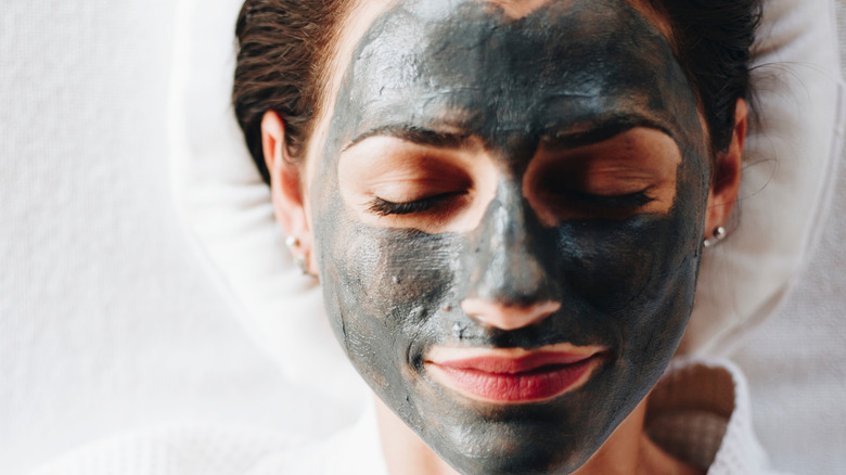 female wearing clay mask