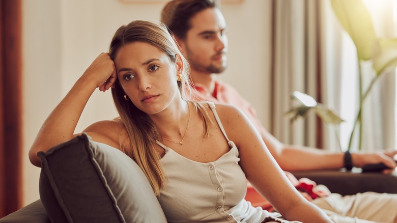 unhappy couple on sofa