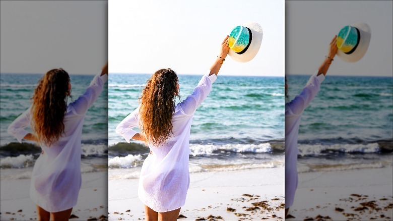 Woman holding tropical print hat