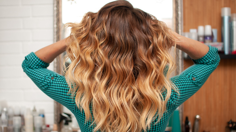 Woman finger combing curls