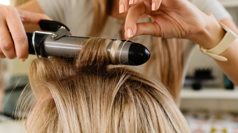 Woman using curling iron