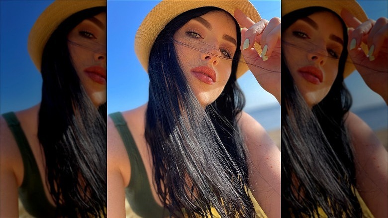 woman with witchy brunette hair cowboy hat