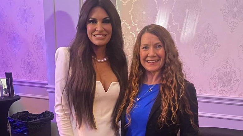 Kimberly Guilfoyle wearing a white dress and terrible hair extensions