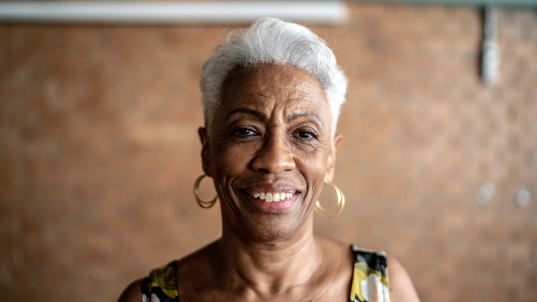 An older woman with white short hair smiling