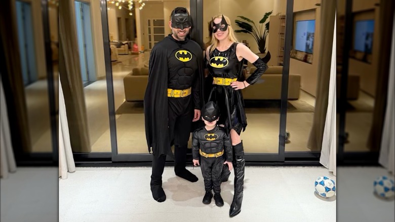 Lindsay Lohan posing in a Batman outfit with her family