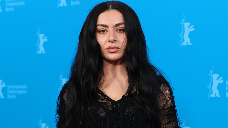 Charli XCX wearing a black dress