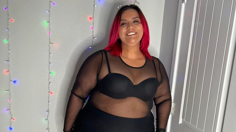 Woman in black mesh outfit