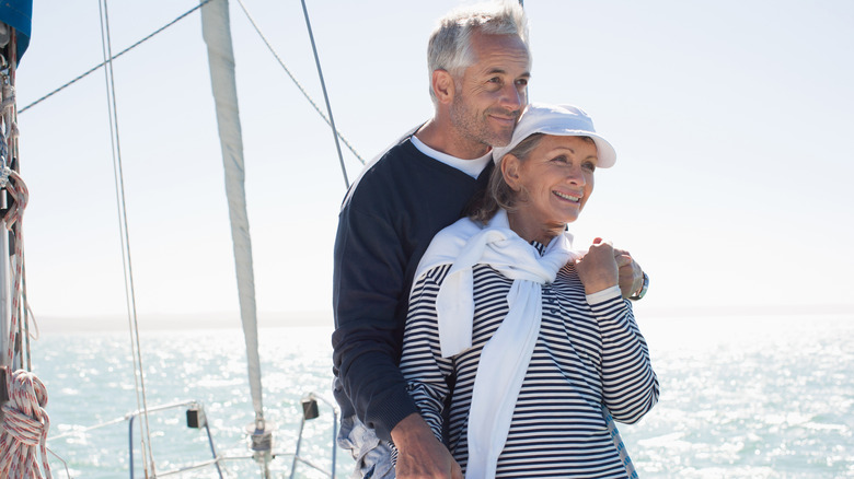Man wearing polo shirt and sweater tied around shoulders