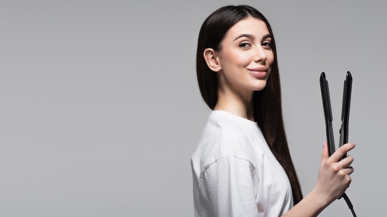 woman holding flat iron