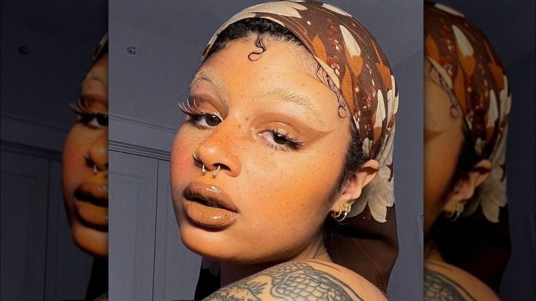 Woman with yellow blush and bleached eyebrows