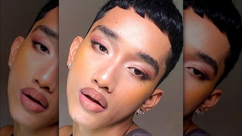 Person with yellow blush and pink eyeshadow