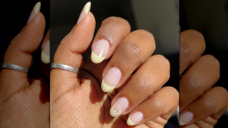 Yellow nail art on fingers