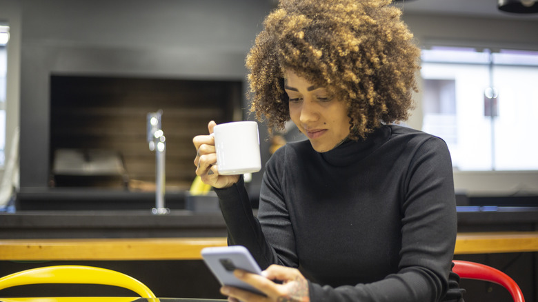 Coffee drinker using phone