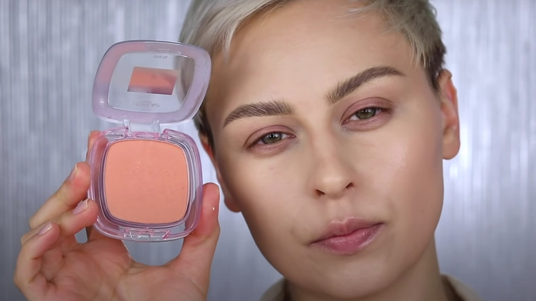 woman holding powder blush