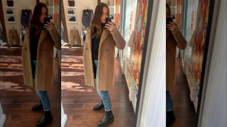 Girl wearing longline shearling coat.