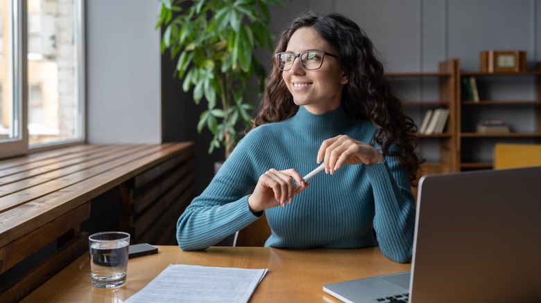 Woman on computer by window