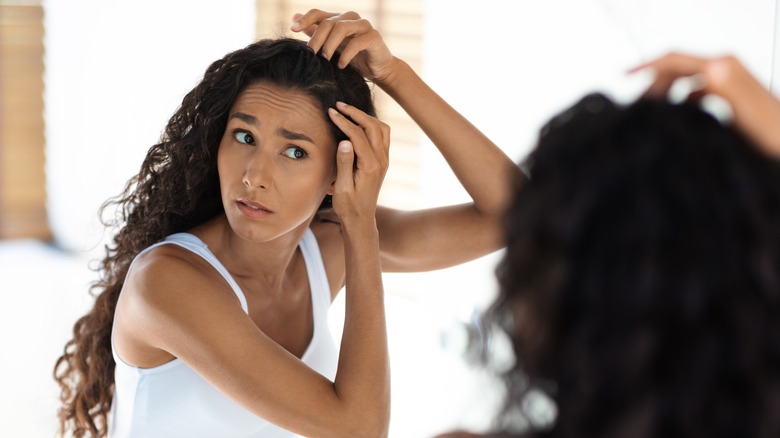 woman touching scalp