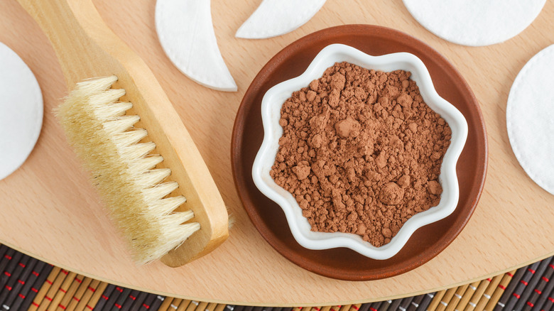 A bowl of cocoa powder sat next to a brush